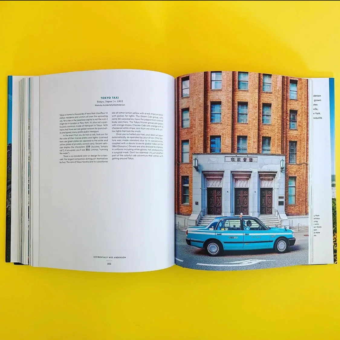 Open book page featuring an article about Tokyo taxis, showcasing a blue and white taxi parked in front of a historic building in Tokyo, Japan. The background features a vibrant yellow color, enhancing the visual appeal of the image.