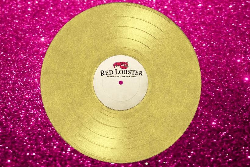 Golden vinyl record with Red Lobster label on a glittery pink background.