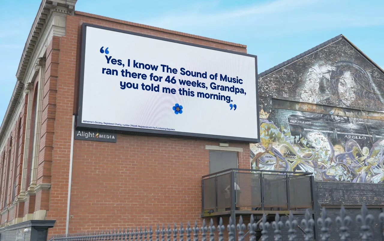 Billboard on a brick building with Alzheimer's Society message about The Sound of Music.