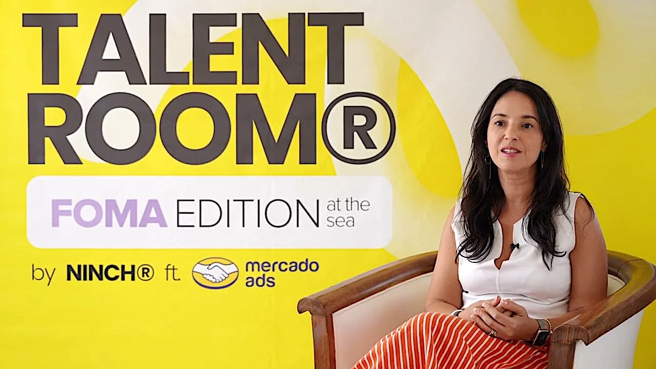 Woman sitting in a chair at Talent Room FOMA Edition event by Ninch and Mercado Ads, yellow and white background.