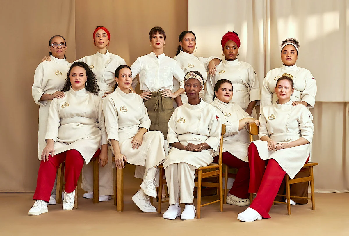 Group of diverse female chefs in uniforms posing together in a professional setting