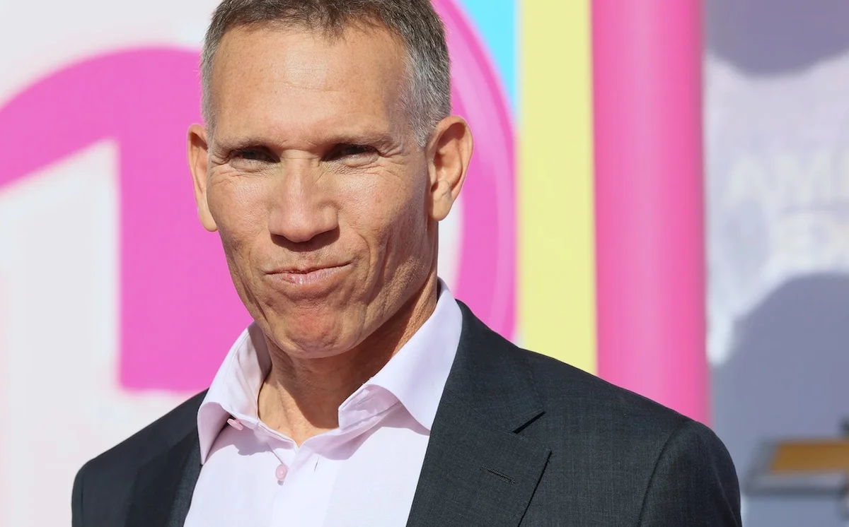 Man in a suit at a colorful event background