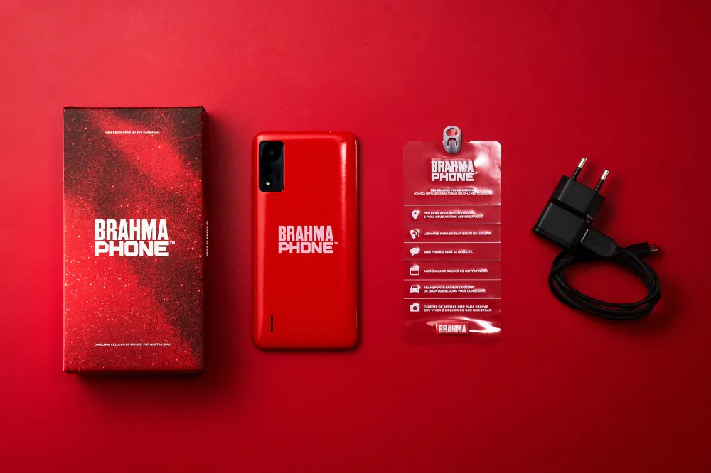 Red Brahma Phone with box, user manual, and charger on red background