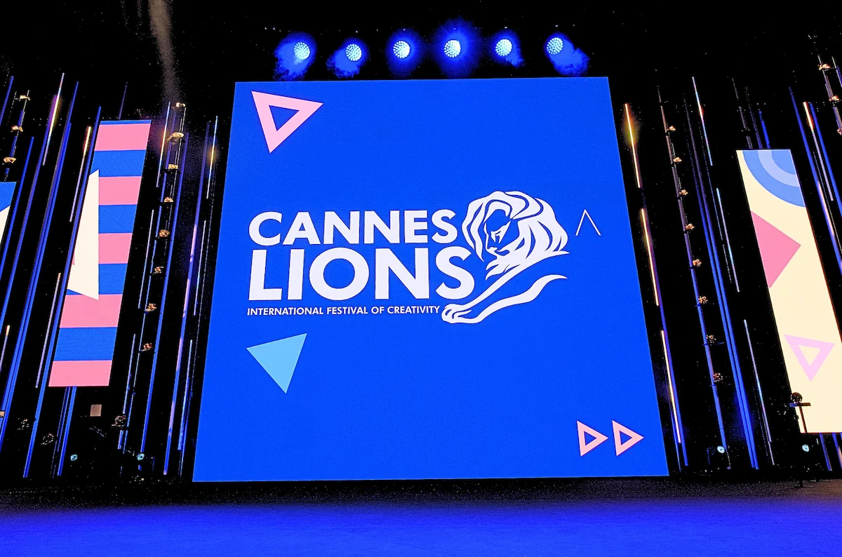 Cannes Lions International Festival of Creativity logo displayed on a large blue screen with stage lights.