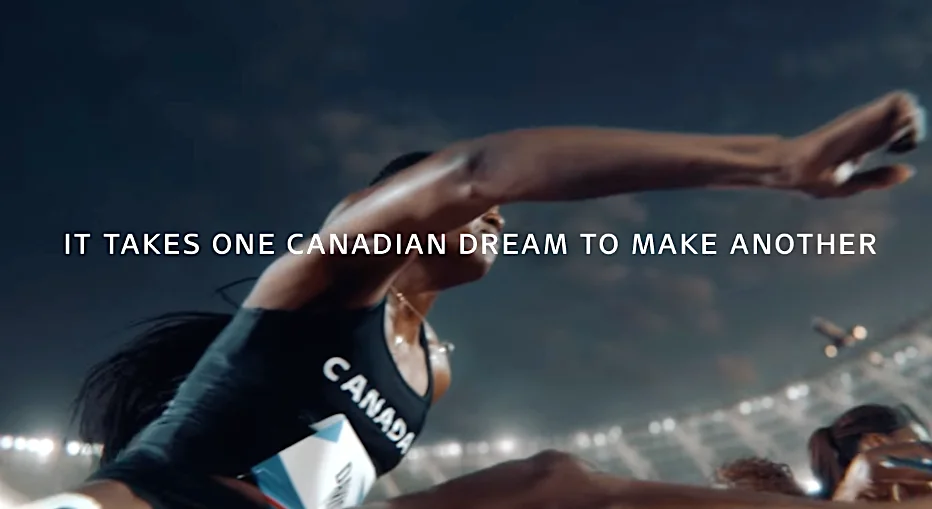 Canadian athlete in black uniform jumping over hurdle with motivational text in background