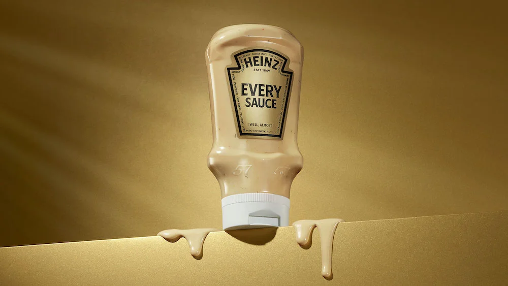 Heinz Every Sauce bottle on a gold background with sauce dripping from the cap.