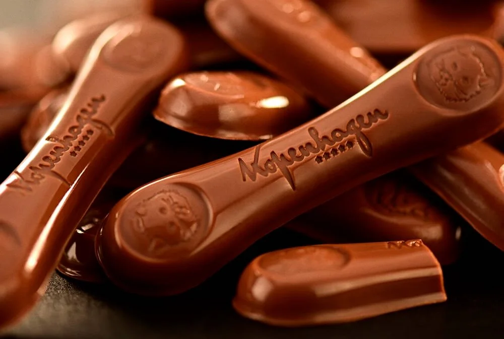 Close-up of Kopenhagen chocolate pieces with embossed logo.