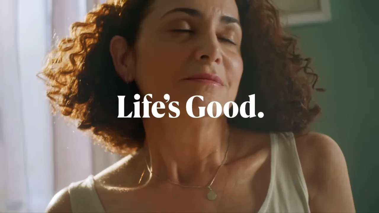 Woman enjoying a moment of peace with "Life's Good" text overlay.