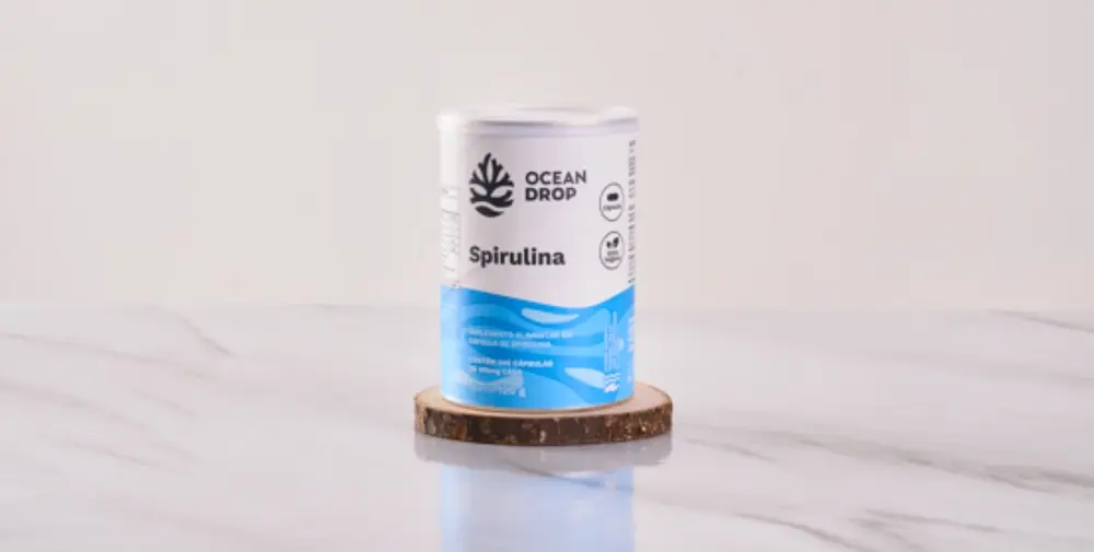 Pote de Spirulina Ocean Drop sobre base de madeira.
