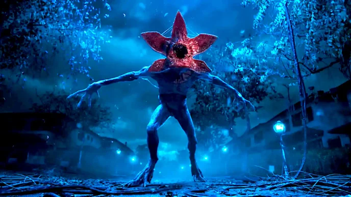 Monstro com cabeça de flor em floresta à noite.