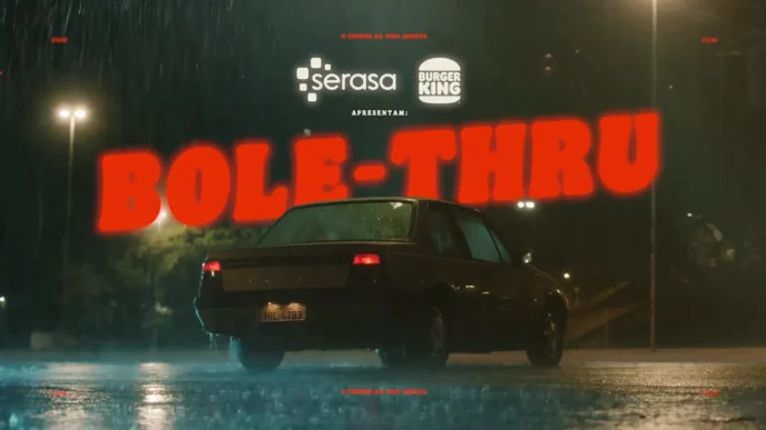 Carro na chuva com letreiro vermelho.