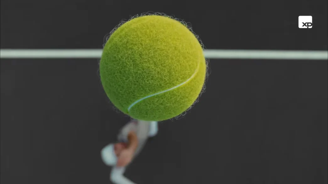 Bola de tênis em foco sobre jogador