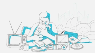 Pessoa cercada por dispositivos eletrônicos antigos.