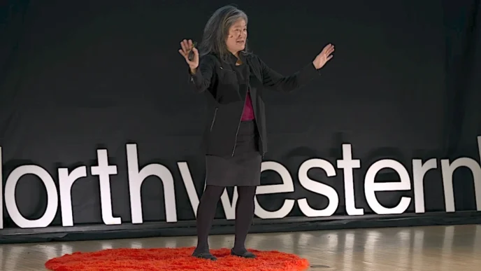 Mulher palestrando em palco com logo Northwestern